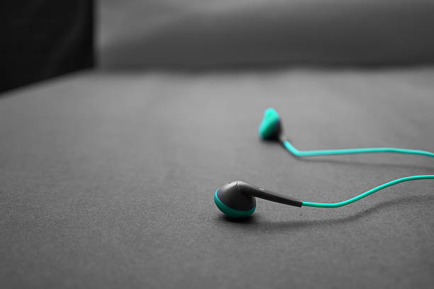 istock earphones on dark textured background. 636452506