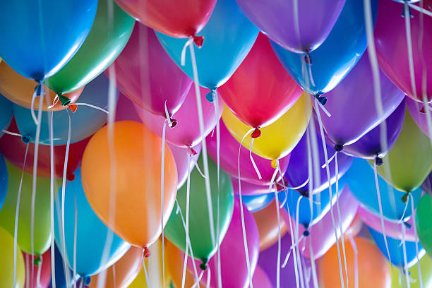 festive, colorful balloons with helium attachment to the white ribbons - helium imagens e fotografias de stock