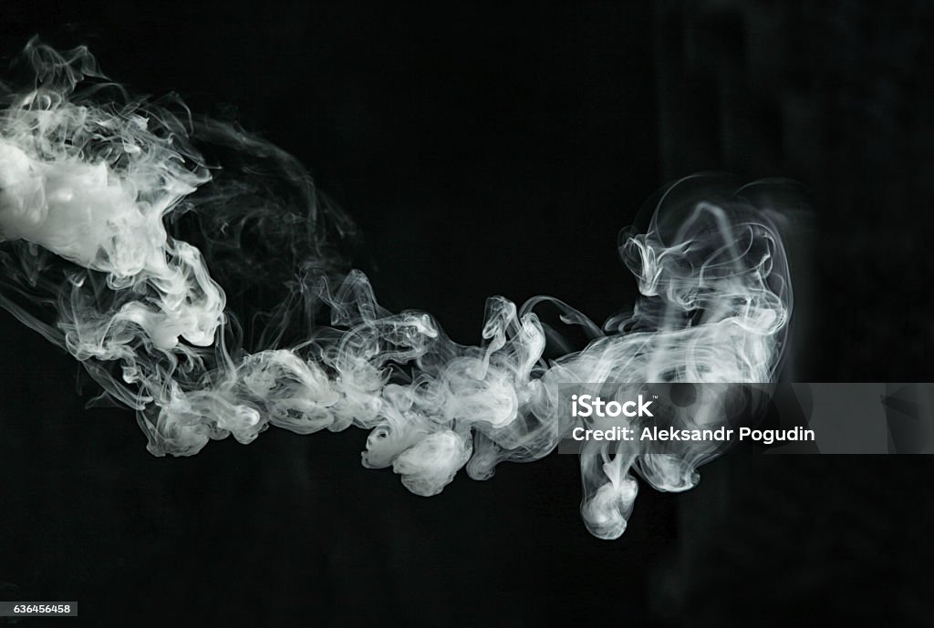 Vapor like smoke on a dark background This photo belongs to my collection "Lifestyle". Here is revealed the topic of vaping and vape tricks. In my portfolio You will find lots of photos on various subjects. I wish You success and I will be glad if You choose my pictures.  Smoke - Physical Structure Stock Photo