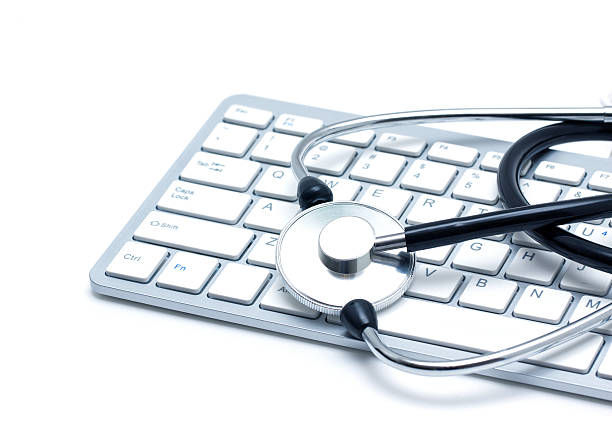 stethoscope and keyboard isolated on white background - computer bug stethoscope computer problems imagens e fotografias de stock