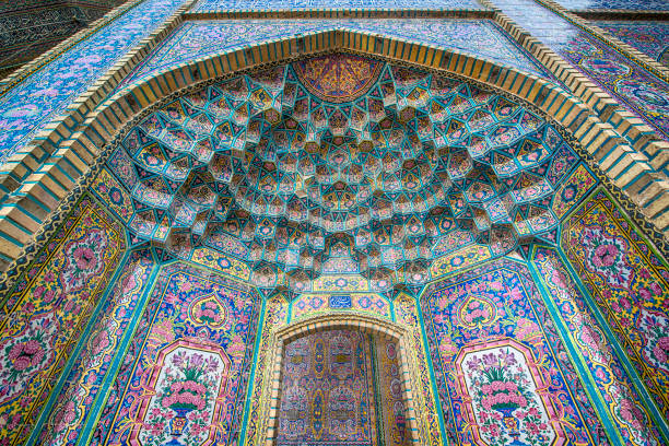 Ceiling tilework decoration of Nasir ol Molk Mosque, Shiraz Ceiling tilework decoration of Nasir ol Molk Mosque (also "Pink Mosque) in Shiraz, Iran. The Nasir ol Molk Mosque is one of the main sights of Shiraz. The mosque was built during the Qajar era between 1876 and 1888.The nickname "Pink Mosque" is going back to the considerable pink color tiles for its interior design.  shiraz stock pictures, royalty-free photos & images