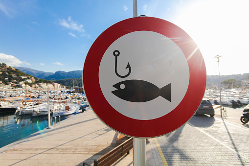 A fishing sign in Mallorca, Spain. Probably this sign represents that fishing is forbidden here.