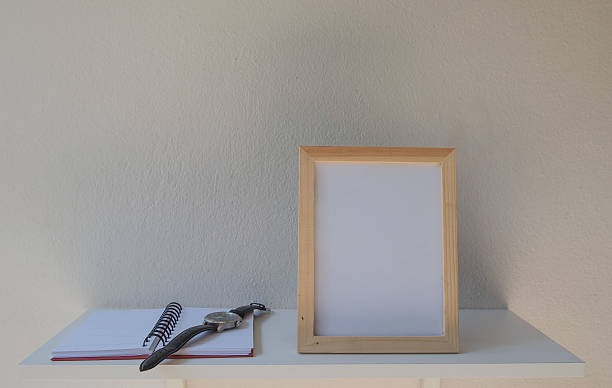 istock photo Frame on a wooden and book on White background 636462360