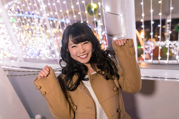 Young girl smiling to camera in Christmas light