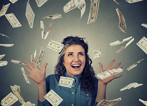 istock woman under money rain falling down dollar bills banknotes 636462470