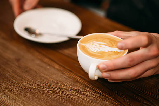 istock Man hands holding a cap of coffee. 636464308