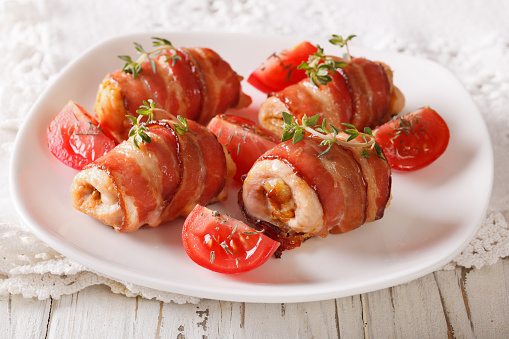 Delicious Chicken rolls with cheese and bacon on a plate close-up. horizontal