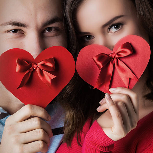 istock Couple with valentine's heart cards 636465390