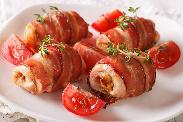 istock Stuffed chicken breast wrapped in bacon close-up. horizontal 636465992