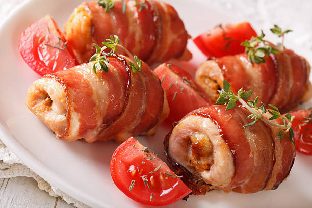istock Chicken breast wrapped in bacon with thyme macro. horizontal 636466076