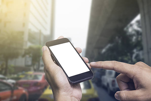 istock Man using his Mobile Phone outdoor, close up . 636466560