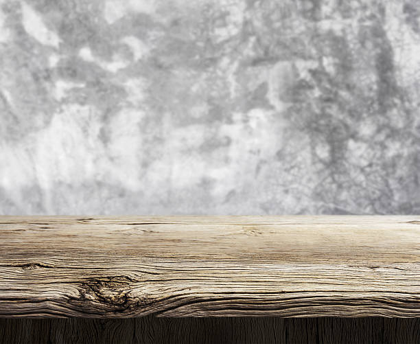 istock Wood shelf on cement background 636467520