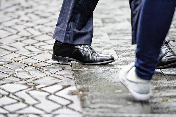 istock Suit walking on rain wet street 636468794