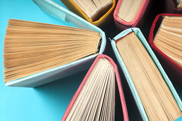 istock Top view of bright colorful hardback books in a circle. 636469846