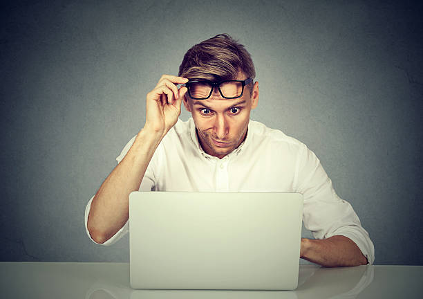 istock Confused shocked man looking at his laptop 636471656