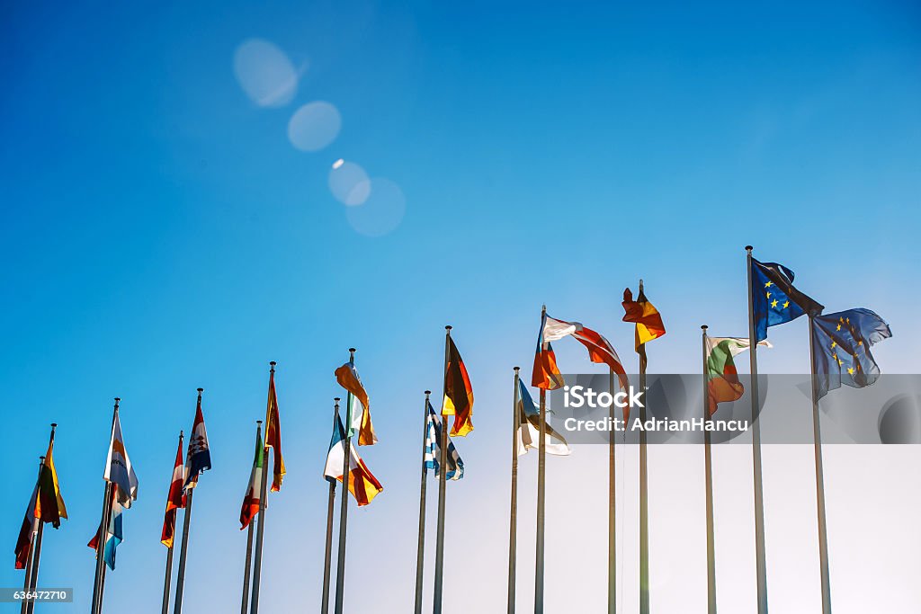 European Union flags against blue sky Flags in front of the European Parliament against beautiful blue sky in Strasbourg, Alsace, France European Union Stock Photo