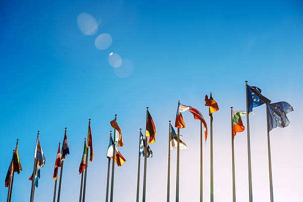 European Union flags against blue sky Flags in front of the European Parliament against beautiful blue sky in Strasbourg, Alsace, France diplomacy stock pictures, royalty-free photos & images