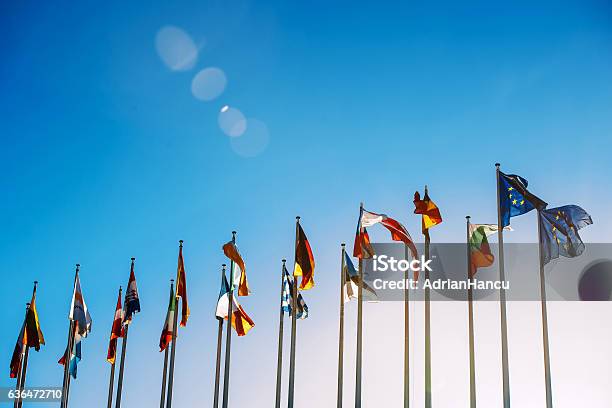 European Union Flags Against Blue Sky Stock Photo - Download Image Now - European Union, National Flag, Europe