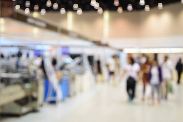 istock blurred image abstract people walking in shopping centre. 636475494