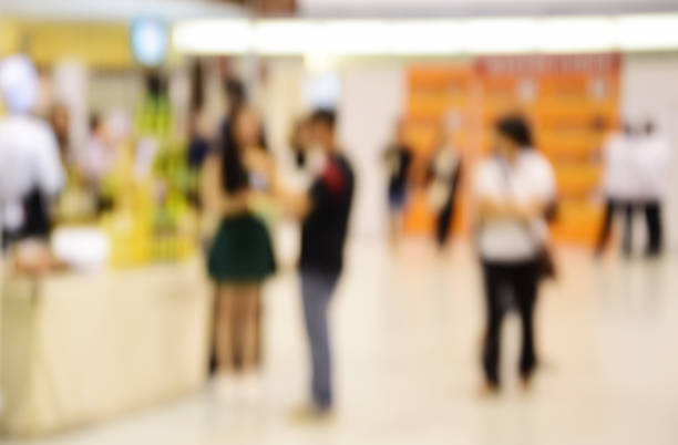 istock blurred image abstract people walking in shopping centre. 636475834