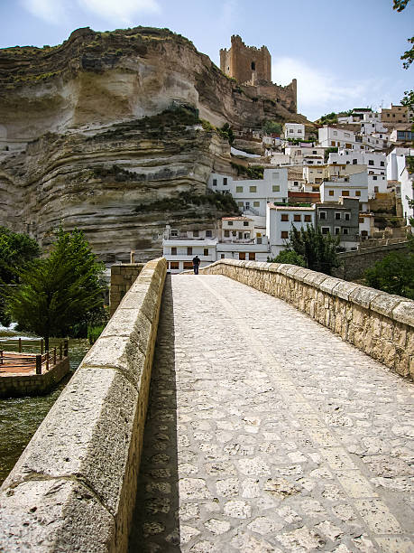 Cityscape with bridge over river at Alcala del Jucar in Castilla la Mancha, Spain