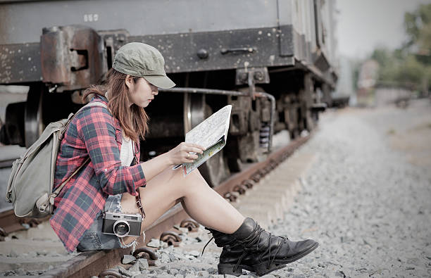 istock Hipster woman traveler holding map on hand. 636479906