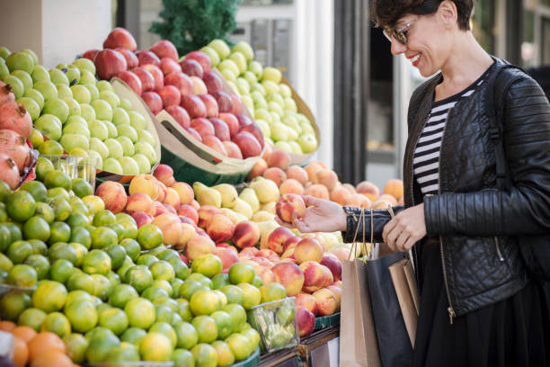 istock young woman buying vegetables 636480728