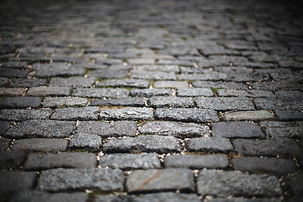 istock blur image of perspective old cobblestone pavement. background, texture. 636484286