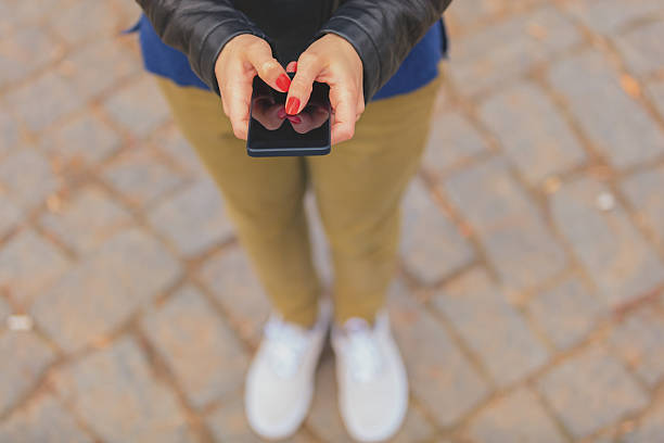 istock Girl using cellphone outdoors. 636485080