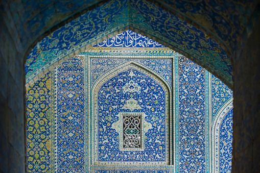 Ceiling and wall tilework at the Shah Mosque on Imam Square, Isfahan, Iran. The mosque is also known as Imam Mosque and Jaame' Abbasi Mosque. It is one of the masterpieces of Iranian/Persian Architecture and an excellent example of Islamic era architecture of Iran and also one of the top sights of the contry.