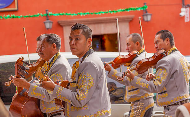 Mariachi Band Violin Players Jardin San Miguel de Allende Mexico San Miguel de Allende, Mexico - December 27, 2014: Mariachi Band Violin Players Jardin Town Square San Miguel de Allende Mexico. san miguel de cozumel stock pictures, royalty-free photos & images