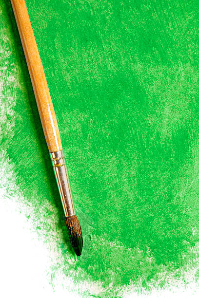 istock Paintbrush with green paint (on white) 636488740