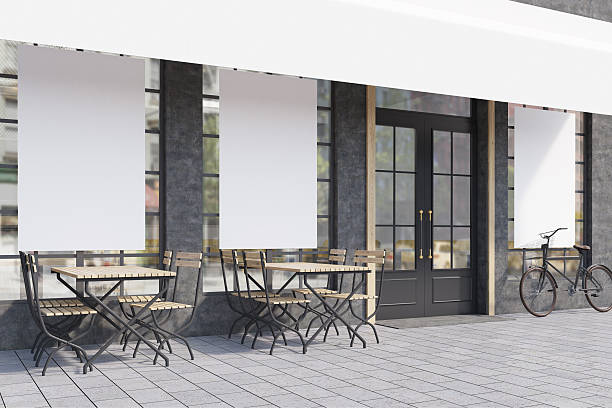 istock Side view of cafe windows with posters 636489392