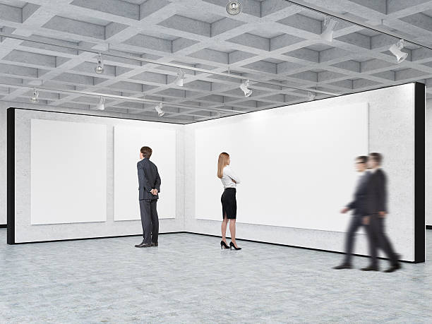 istock Man and woman are looking at blank posters 636492916