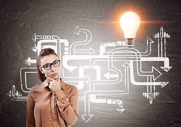 istock Woman and arrows with orange light bulb 636492962