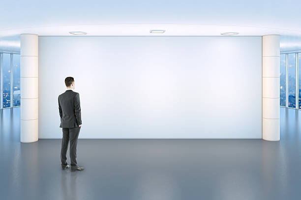 Businessman looking at blank wall