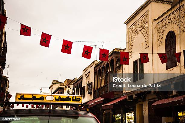 Moroccan Flags And Taxi Parked On The Street Stock Photo - Download Image Now - Flag, Morocco, Africa