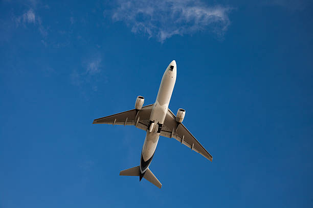istock The plane in the bright blue sky with no clouds 636503974