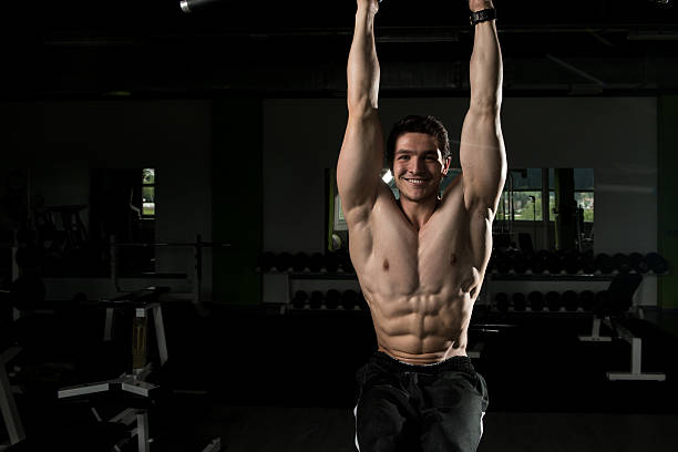 istock Young Man Performing Hanging Leg Raises Exercise 636507140