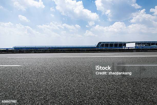 Asphalt Road Under The Blue Sky Stock Photo - Download Image Now - Motor Racing Track, Asphalt, Backgrounds