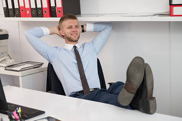 istock Young Businessman Relaxes Sitting In The Office 636508484