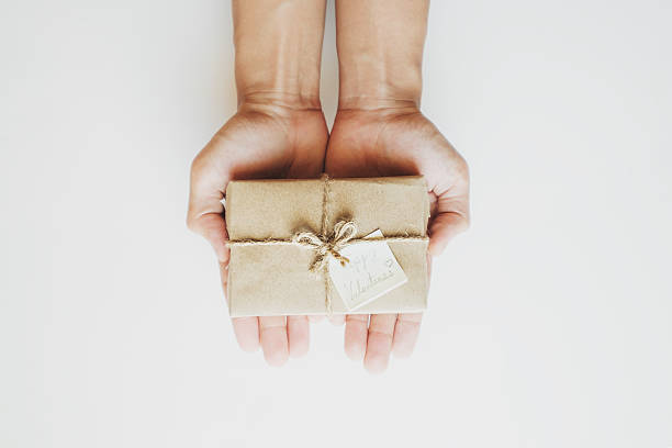 istock Hand holding gift box, with happy valentines day card 636510310