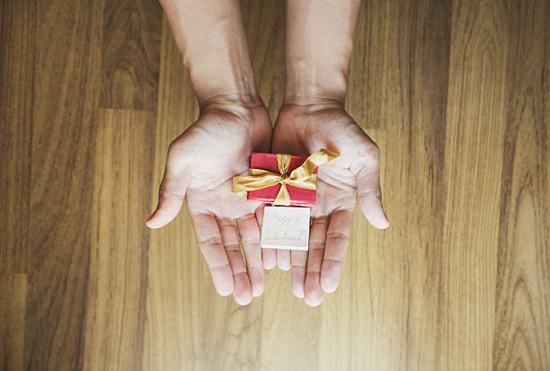 istock Hand holding red gift box, with happy valentines day card 636510378