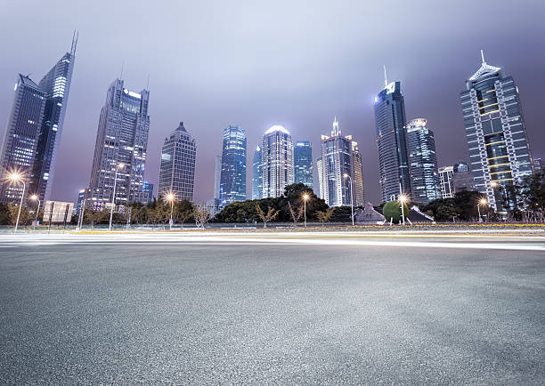 city avenue with modern buildings at night