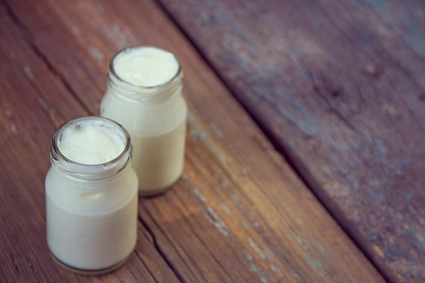 istock Yogurt in jar on the wooden table 636512956