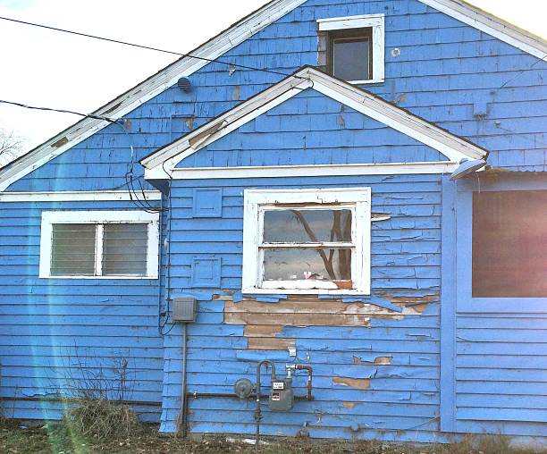 Peeling paint on an old blue house