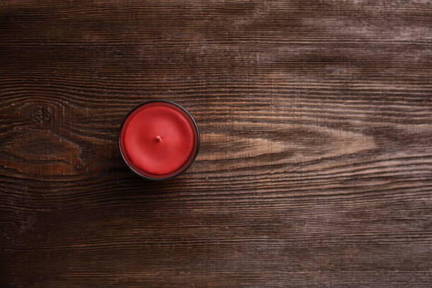 Red Candle on Wooden Background. Top View