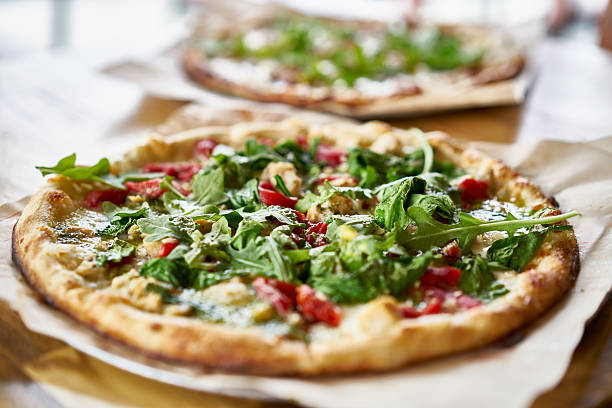 authentic gourmet pizza with fresh arugula, pesto and chicken