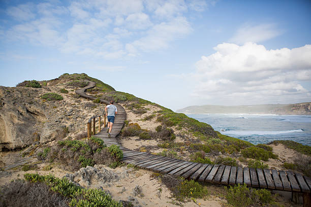 istock Male enjoying his run along the rugged coastline 636515858