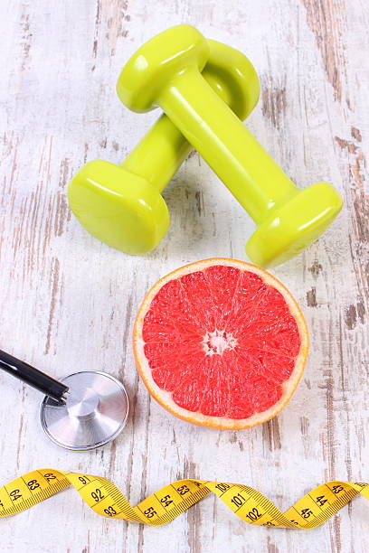 istock Fresh grapefruit, centimeter, stethoscope and dumbbells, healthy lifestyles 636519336